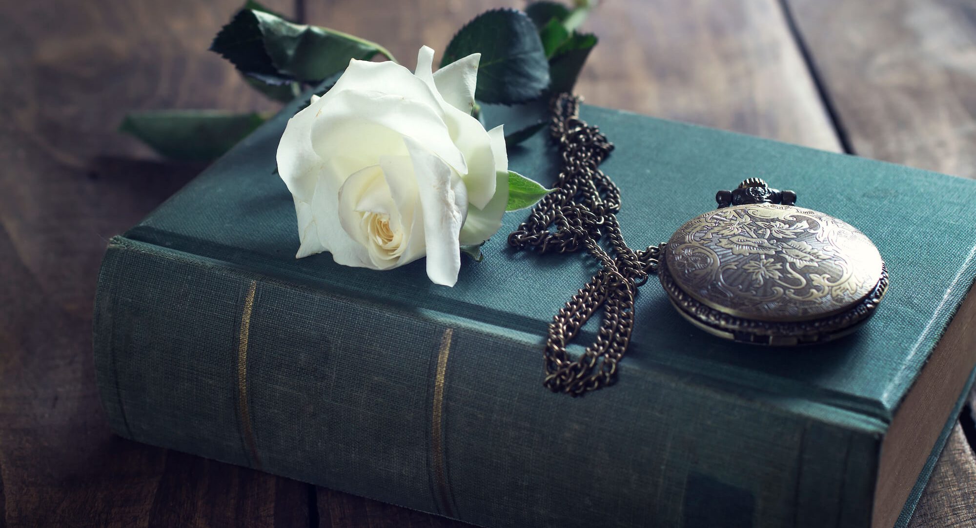 Vintage pocket watch on old books.