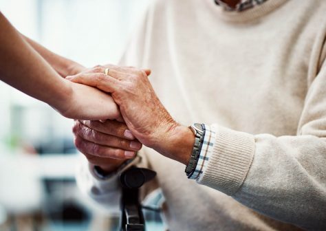 Cropped shot of an unrecognizable female nurse holding her senior patient's hand in comfort