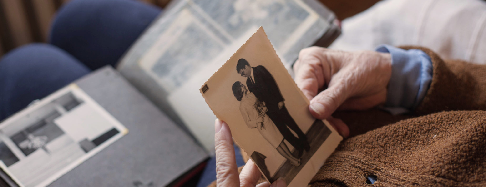 Senior woman looking at her wedding photo.